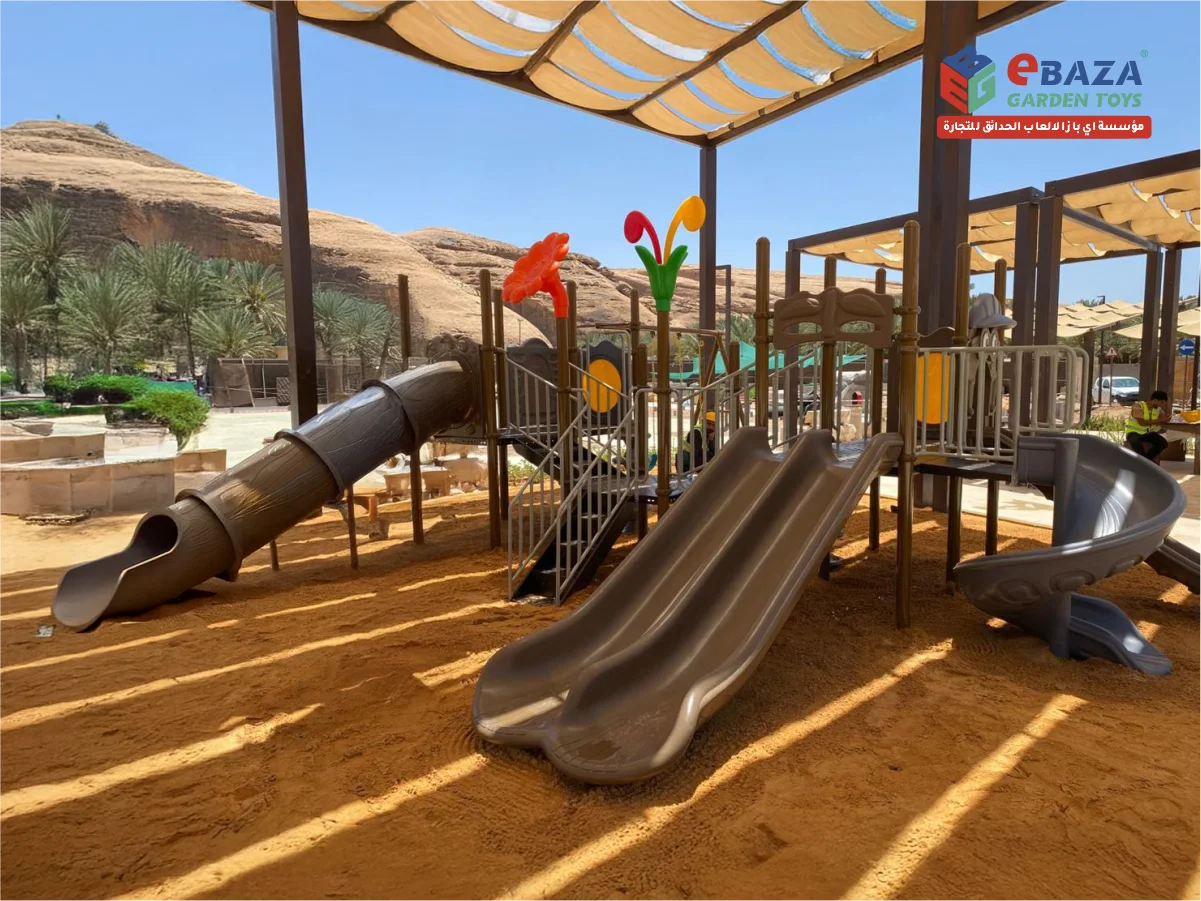 Outdoor playground and fitness installation at Therba Medical Center AlUla by Ebaza Gardens, featuring slides, climbers, outdoor gym, and safe flooring.