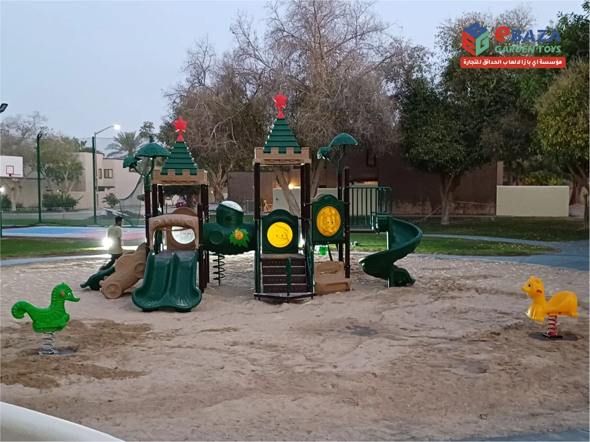 Playground installation at Saudi Aramco Residential Camp Dhahran by Ebaza Gardens, featuring slides, swings, spring riders, and safe sand play areas.