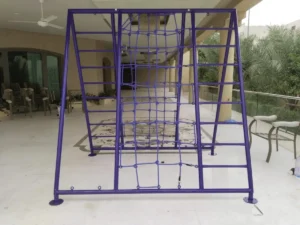 Outdoor kids’ climbing frame with purple metal frame, side ladders, and central rope climbing net installed in a villa play area.