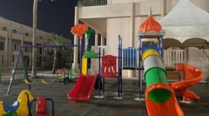 Outdoor kids slides in Saudi Arabia with tube slide, spiral slide, and double slide in a playground area.