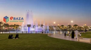 King Abdullah Park in Riyadh with the dancing fountain, green lawns, walking paths, and Saudi families enjoying the park in the early evening.
