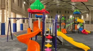 School playground with colorful slides and a swing set for children.