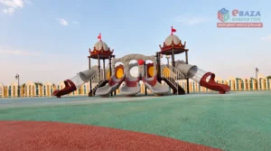 Rubber playground flooring beneath outdoor playground equipment with slides and play towers.