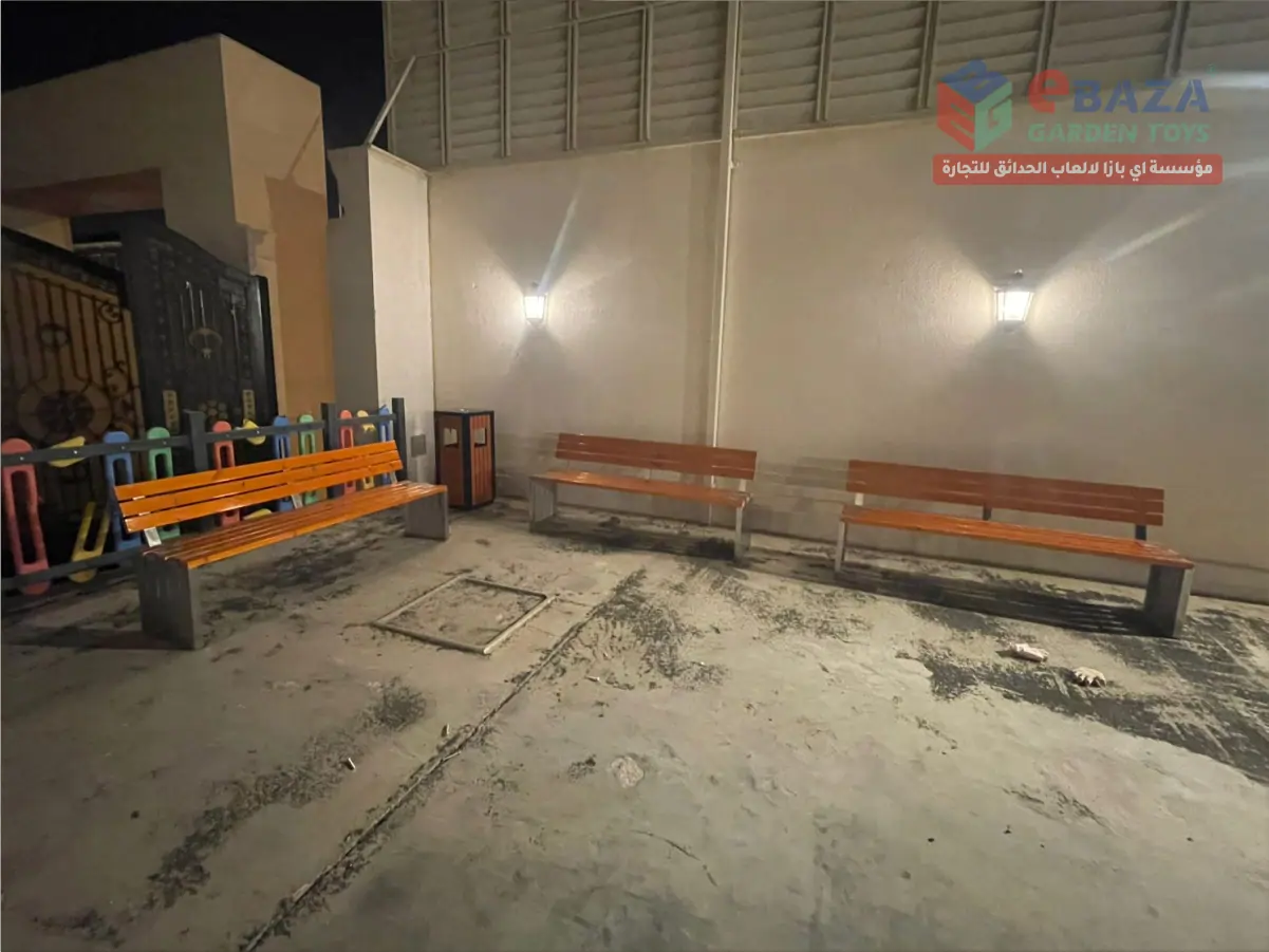 Outdoor wooden bench with metal frame installed in Hail residential seating area by Ebaza Garden Toys.