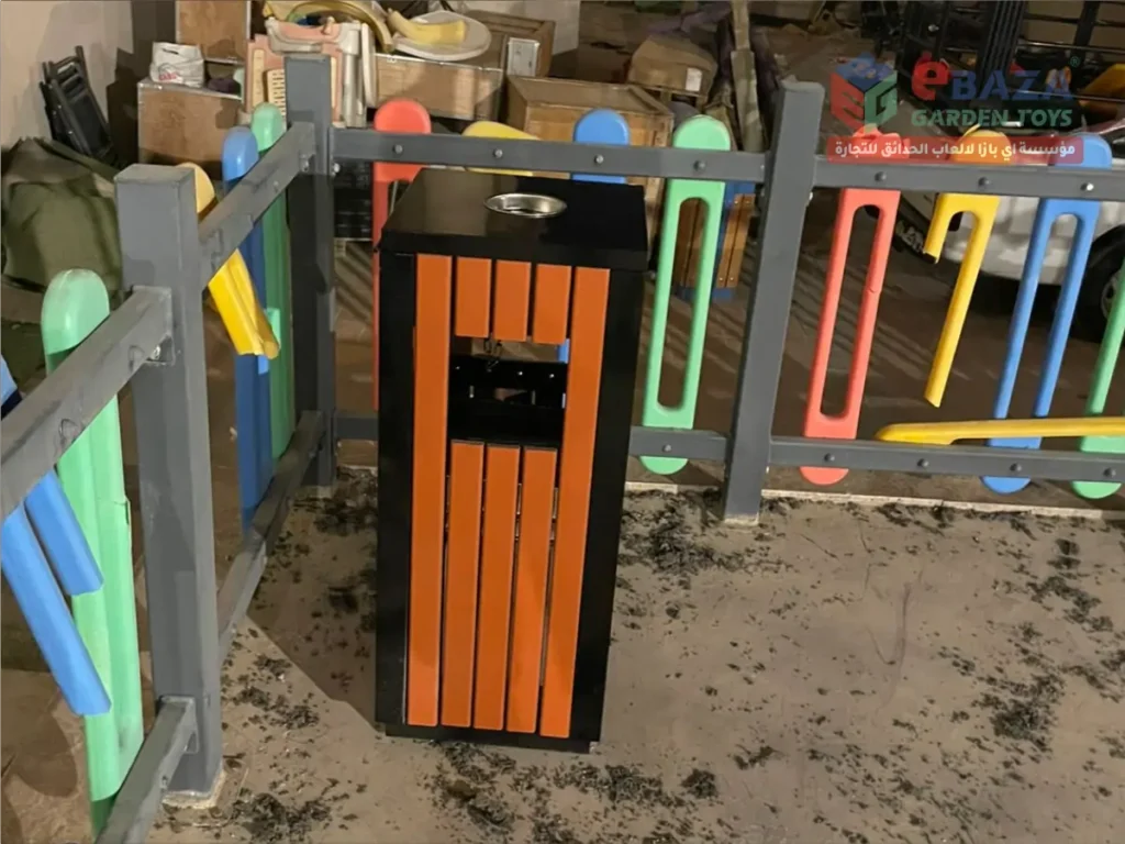 Outdoor dustbin installed beside colorful safety fence in Hail outdoor seating project.