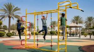 Children playing on a climbing and monkey bar set with yellow steel frame, side ladders, rope climbers, and safety flooring in an outdoor playground.