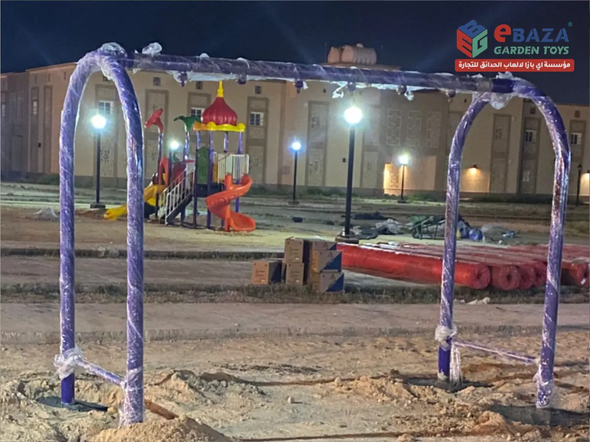 Heavy-duty galvanized steel outdoor swing frame being installed by Ebaza Gardens for a residential playground in Hail, Saudi Arabia.