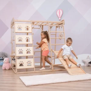 Indoor wooden kids climbing playset with slide, climbing wall, ladders, monkey bars, rope, and activity rings.