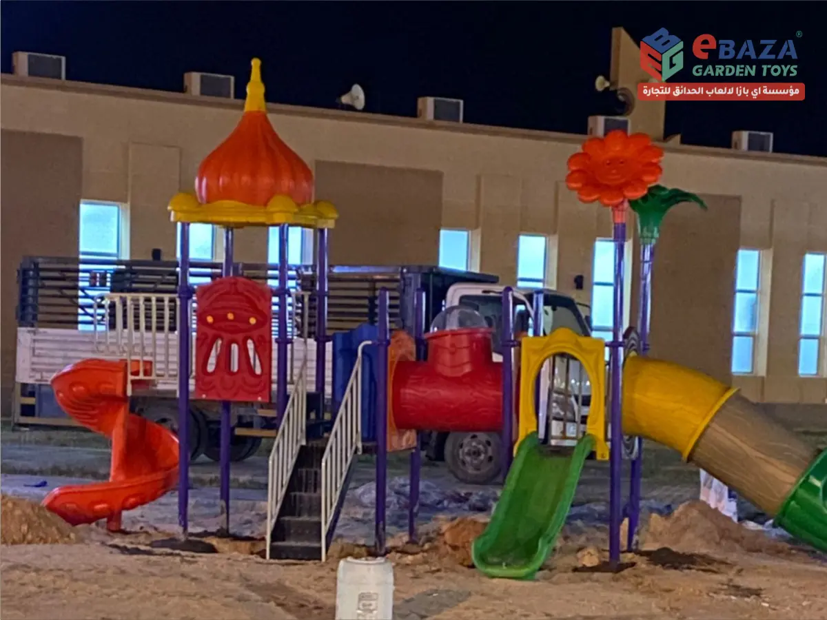 Completed school playground installation in Tabuk featuring a multi-play structure with spiral slide, tunnel slide, straight slide, crawl tunnel, and themed play towers by Ebaza Gardens.