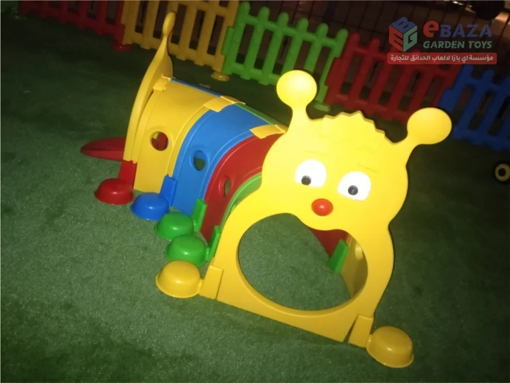 Colorful caterpillar-shaped children’s crawl tunnel installed on artificial grass.