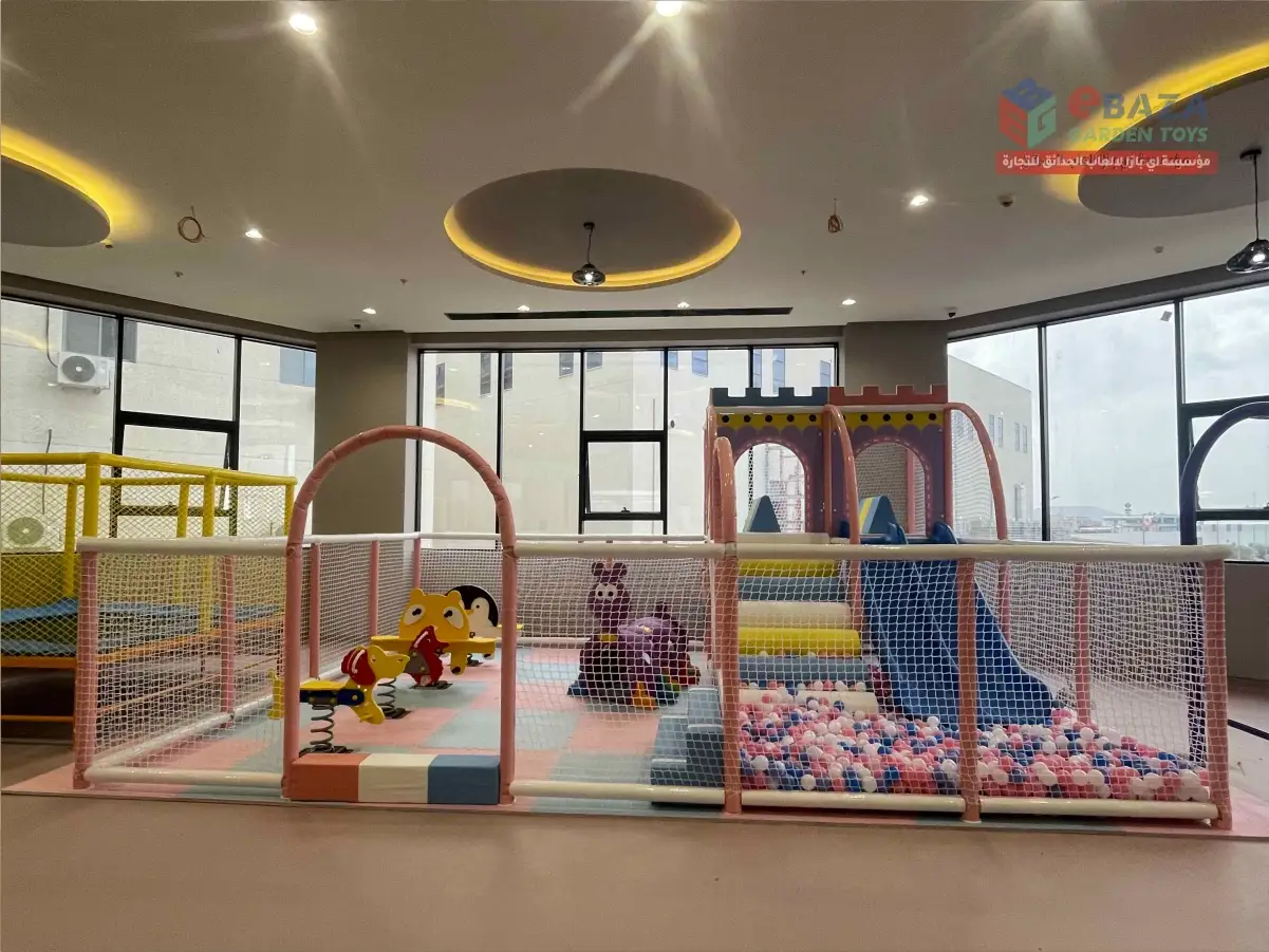 Indoor school playground in Abha with ball pool, slide, spring riders, padded flooring and safety netting.