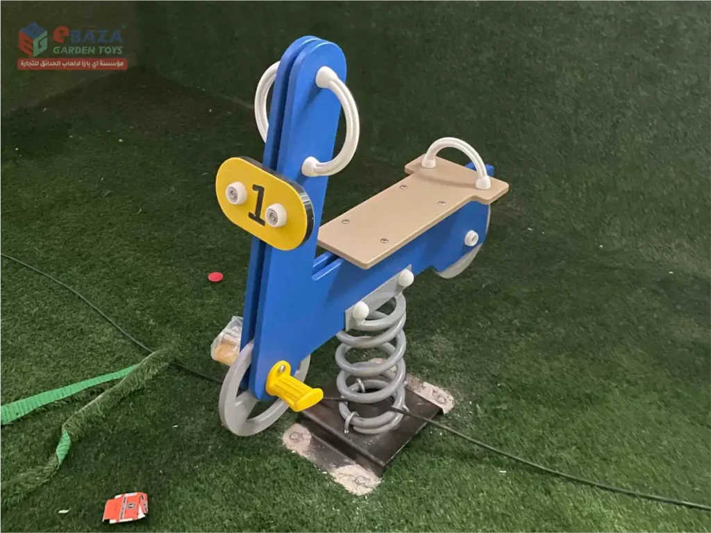 Blue motorcycle spring rider installed in a children’s playground in Riyadh.