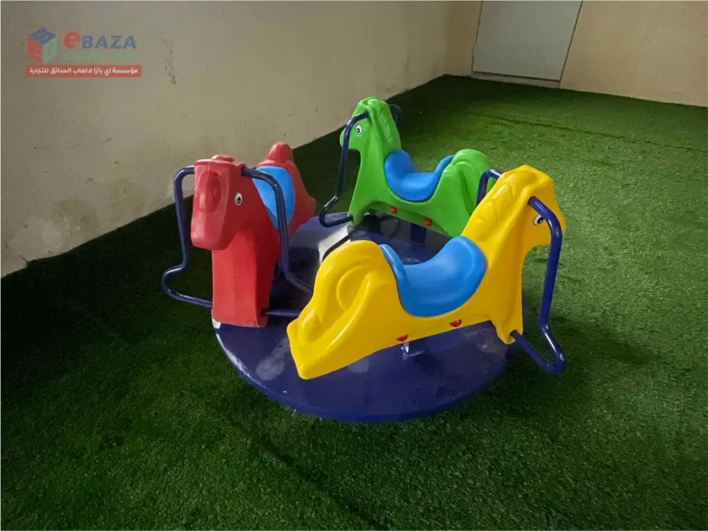 Colorful four-seat children’s merry-go-round installed in an outdoor playground in Riyadh.