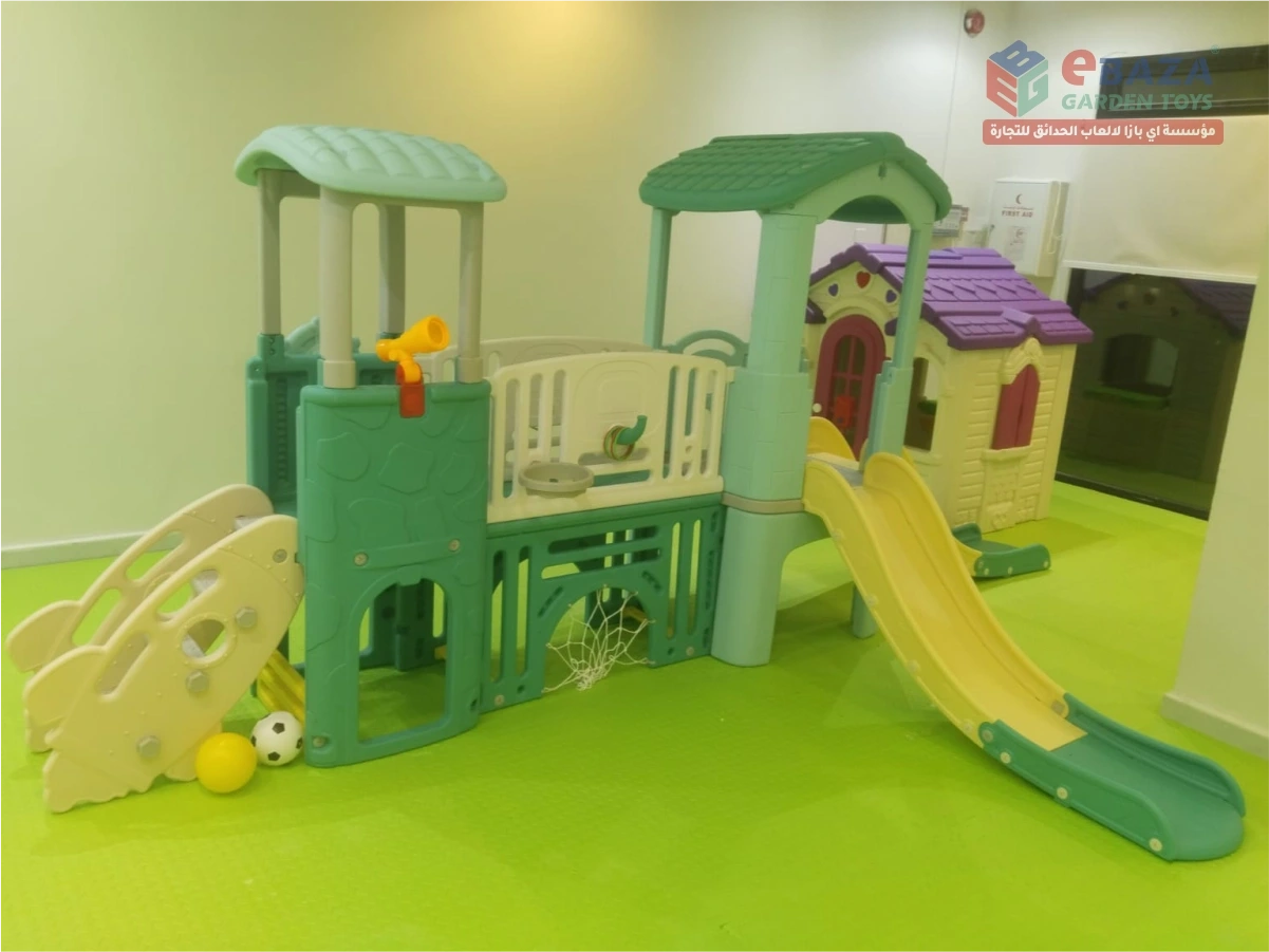 Indoor school playground in Riyadh with slides, climbing structure, playhouse and padded safety flooring.