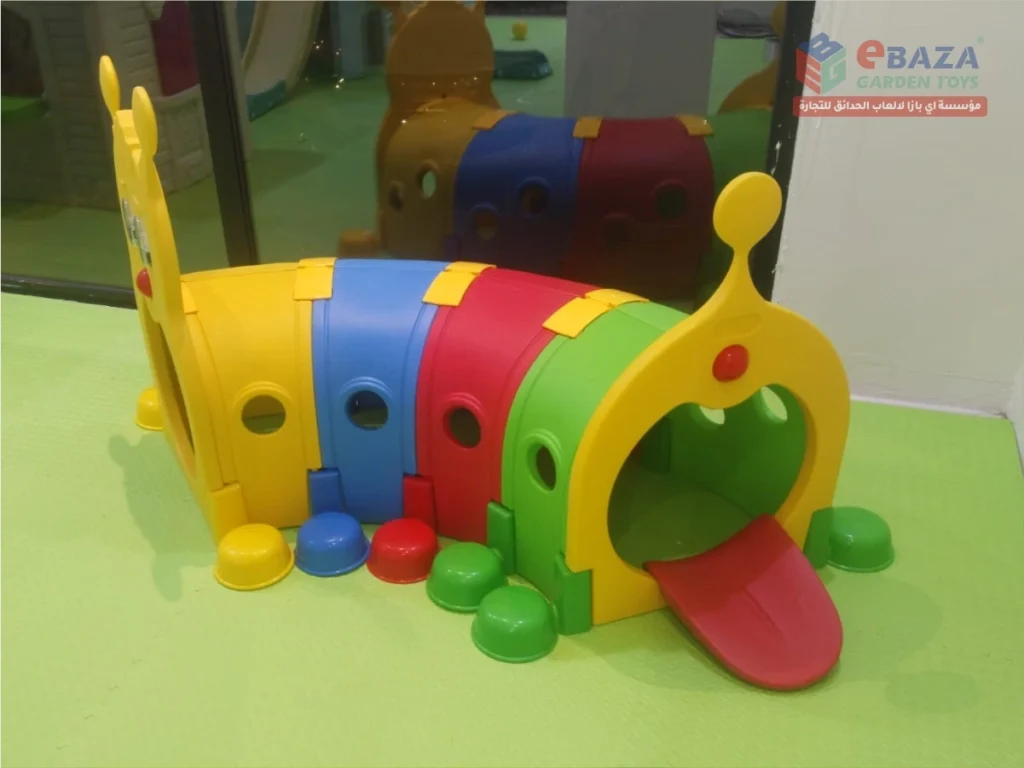 Colourful caterpillar crawl tunnel in an indoor school playground in Riyadh.