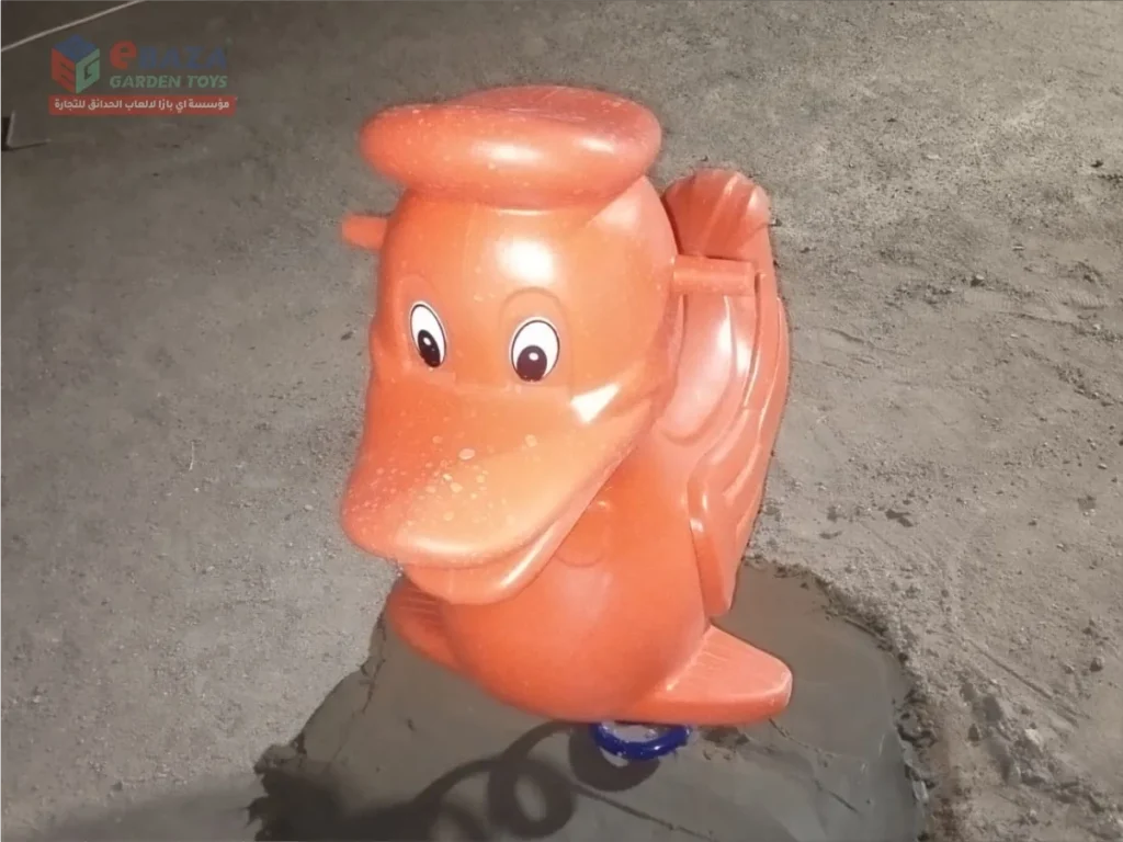Orange animal-shaped spring rider installed in a public park playground in Madina.