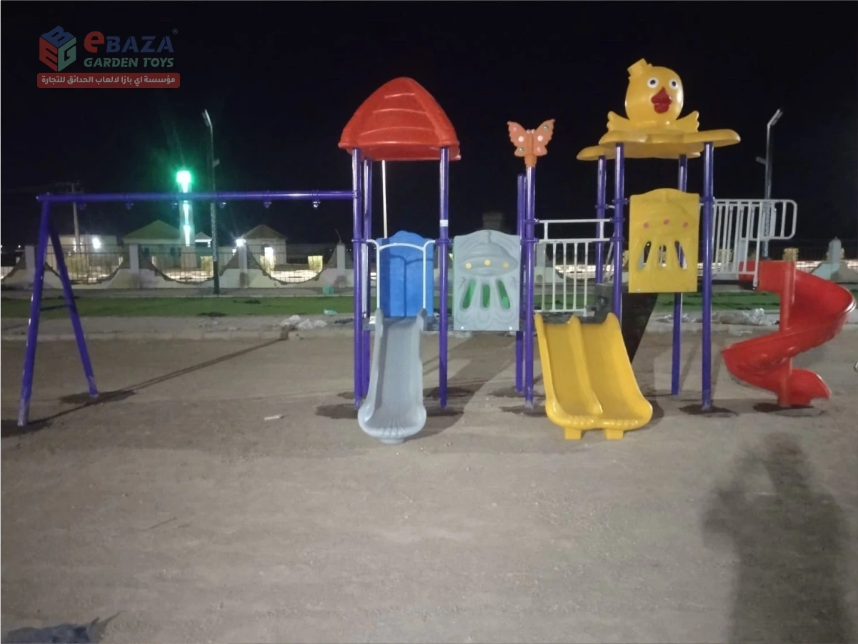 Public park playground in Madina with straight, double and spiral slides, play towers and swing frame.