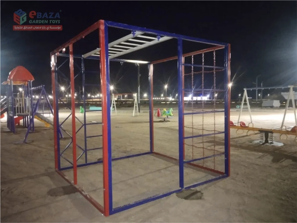 Cube climbing frame with overhead monkey bars and chain climbing nets installed in a Madina public park.