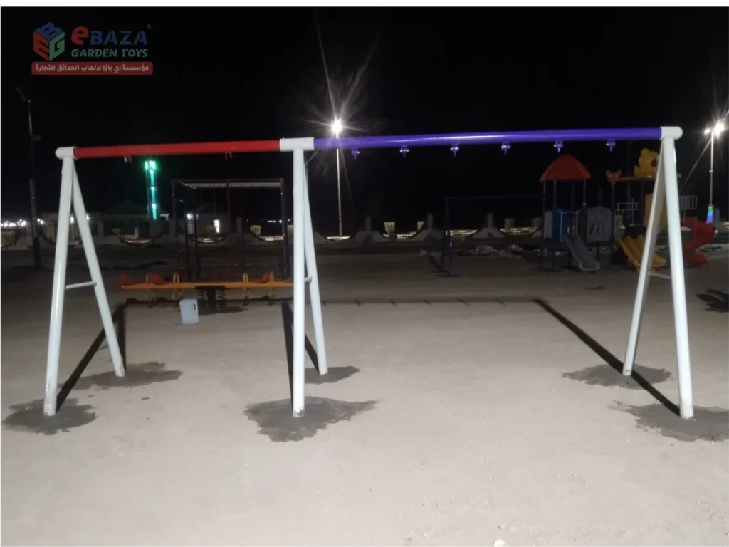 Double-bay steel swing frame with multiple suspension points installed in a Madina public park.