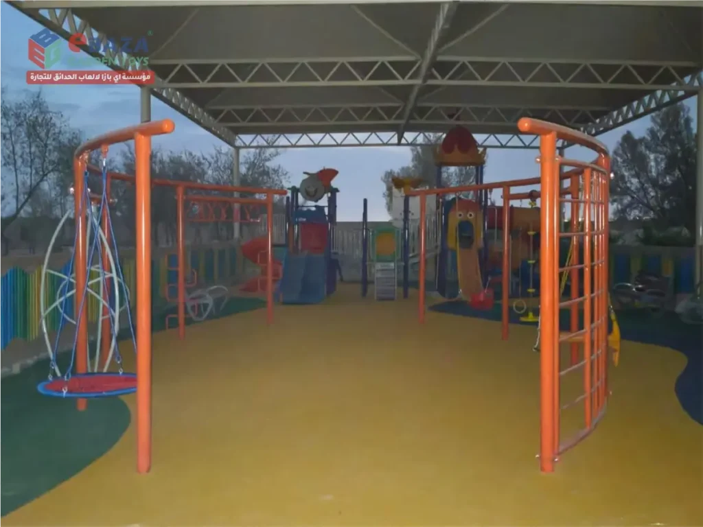 Outdoor playground installation in Al Kharj with basket swing, climbing frames, swings, slides, multi-play equipment and shaded safety flooring.