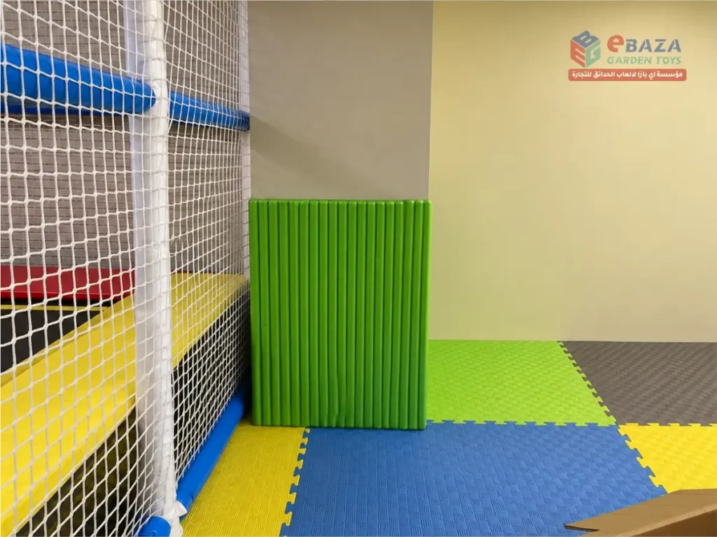 Green protective column padding beside the Alfanar indoor playground in Riyadh.