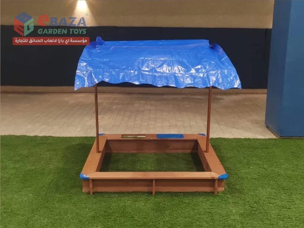 Shaded wooden sand play unit at Beech Hall School Riyadh with timber frame and overhead canopy.
