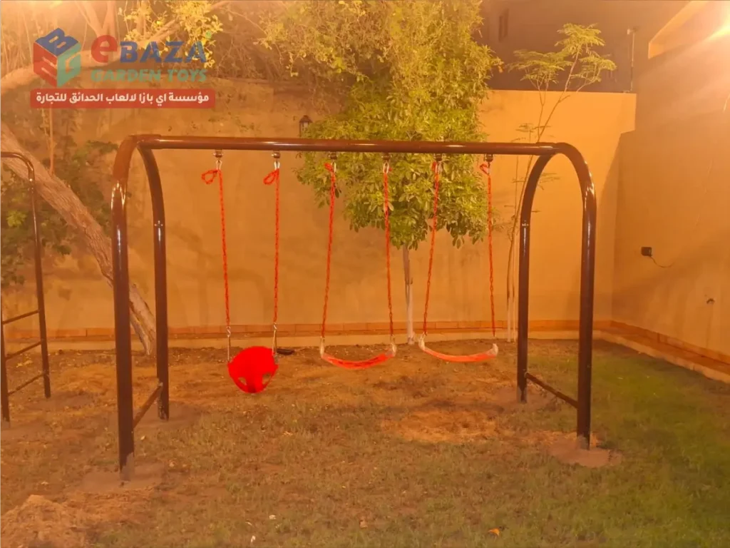 Three-seat outdoor swing set with toddler bucket seat and two standard swing seats at a villa in Al Nuzha, Dammam.