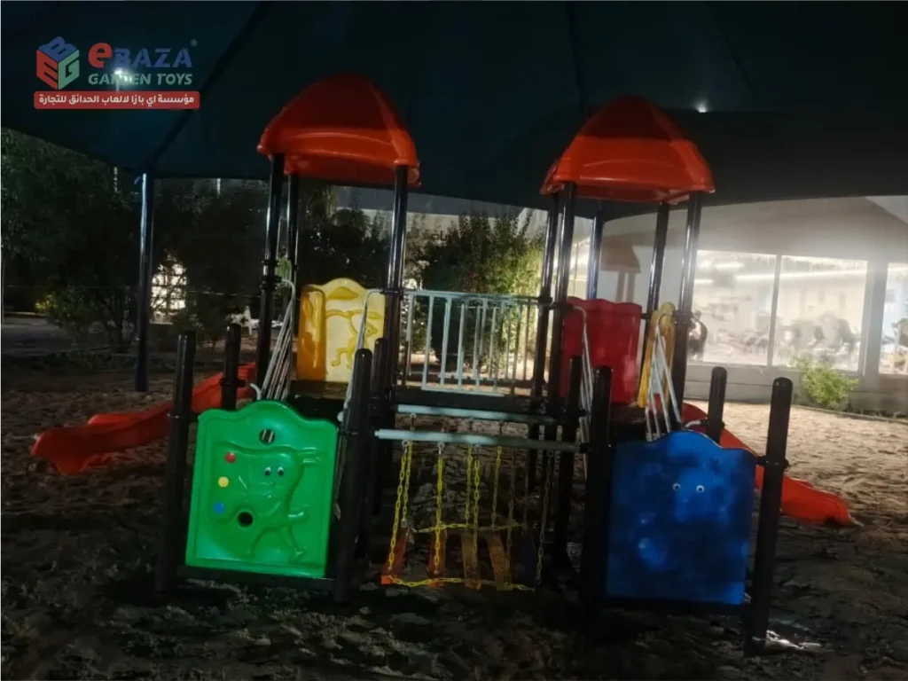 Multi-activity outdoor playground in Ras Tanura at Saudi Aramco Najmah with two play towers, slides, bridge, activity panels and shade.