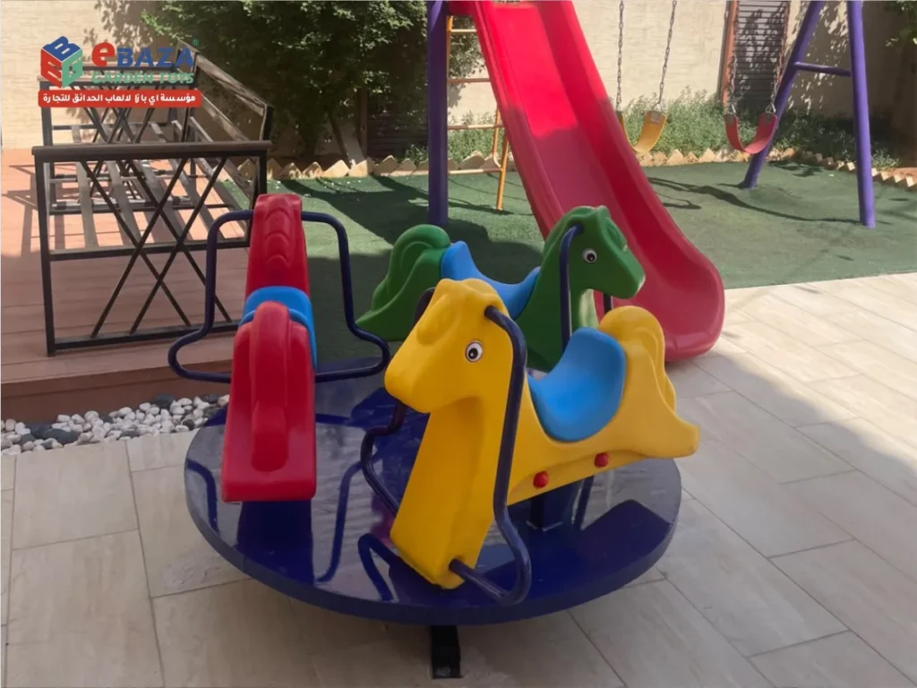 Colourful animal-shaped horse carousel on a round blue base in a home playground in Al Malaz, Riyadh
